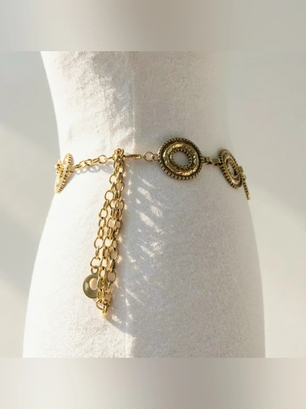 Gold tone metal belt with brass chain, metal circles and metal ball details